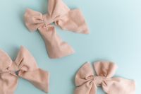Kaboompics - Multiple Pastel Fabric Bows On Light Blue Background Flat Lay