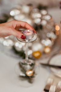 Kaboompics - Hand Lighting a Tealight among Silver Christmas Decorations
