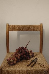 Kaboompics - Red Grapes and Pruning Shears on Woven Chair