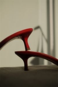 Kaboompics - Sculptural Red Heels with Crochet Flower Details in a Minimal Shadow Study