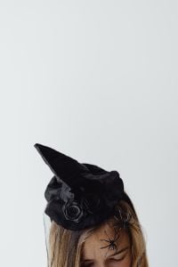 Kaboompics - Woman in Black Halloween Costume Holding a Gray Pumpkin