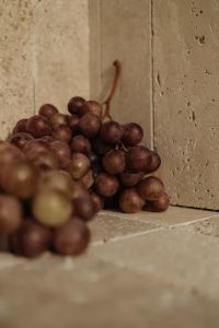 Kaboompics - Close-Up Red Grapes on Travertine Surface
