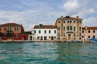 Kaboompics - Pastel Waterfront Facades and Wooden Mooring Posts on a Murano Canal