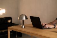 Kaboompics - Man Working on a Laptop at a Warm Wooden Desk
