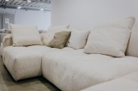Kaboompics - Cream Modular Sectional Sofa with Textured Neutral Accent Cushions