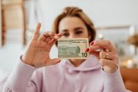Kaboompics - Woman Holding a Ten-Dollar Bill in Front of Her Face