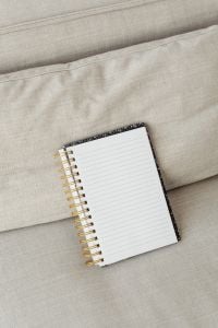 Kaboompics - Open Lined Notebook Mockup on a Beige Sofa Cushion