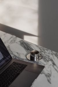 Kaboompics - Laptop and Coffee Cup on Arabescato Marble Table