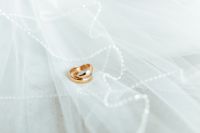 Kaboompics - Golden rings on a white veil