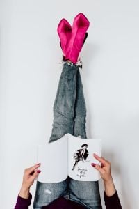 A woman in pink boots and blue jeans