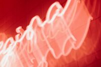 Kaboompics - Glowing Red Neon Light Trails Over Tiled Wall