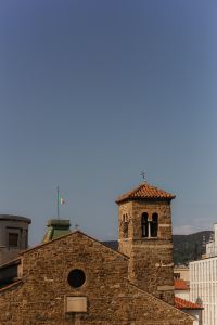 Kaboompics - Trieste Civic Clock Tower with Italian Flag Against Blue Sky