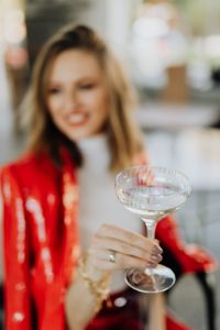 Kaboompics - Champagne Coupe in Foreground with Blurred Woman in Red