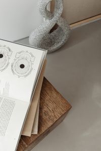 Kaboompics - Open Book and Stone Sculpture on Walnut Pedestal Table