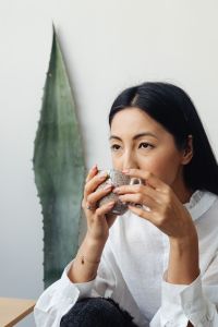 Kaboompics - Woman Holding a Coffee Cup Beside a Chemex