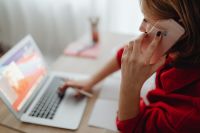 Kaboompics - Woman Working on Laptop while Talking on Phone at Home Office