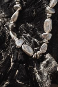 Kaboompics - Close-Up of Silver Metal Necklace on a Black Textured Surface