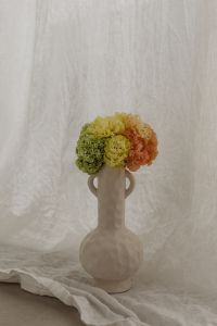 Kaboompics - Tall Ceramic Vase with Clustered Spring Flowers