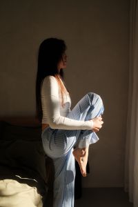 Kaboompics - Woman Relaxing by the Window in Comfortable Home Clothes
