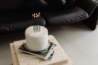 Kaboompics - White Cake with Black Candles on a Coffee Table