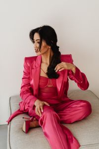 Kaboompics - Asian Businesswoman Adjusting Hair in Pink Satin Suit