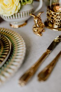 Kaboompics - Gold Bunny Figurine beside Floral Teacup and Layered Gold-Rimmed Easter Plates