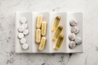 Kaboompics - White Tablets, Bead-Filled Capsules and Golden Softgels on a White Tray