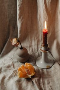 Kaboompics - Burning Red Candle With Citrus And Dried Flower Decor