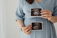 Kaboompics - Close Up of Pregnant Belly with Ultrasound Photos