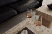 Kaboompics - Wine Glasses on Travertine Table beside Black Leather Sofa