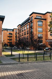 Kaboompics - Brick Loft Apartments Along a Tree-Lined City Street