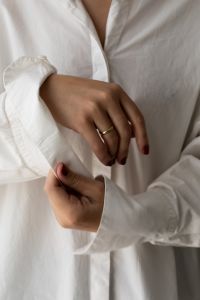 Kaboompics - Woman Adjusting the Cuff of Her White Shirt