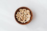 Kaboompics - Cashew Nuts in a Wooden Bowl on Marble for Minimalist Food Backgrounds