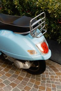 Kaboompics - Pastel Blue Scooter Parked on an Italian Cobblestone Street