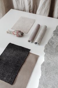 Kaboompics - Neutral Interior Material Samples with Rolled Textiles and Stone