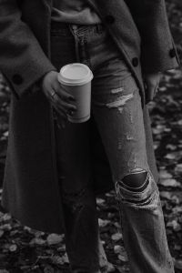 Kaboompics - Black and White Detail of Ripped Jeans and Takeaway Coffee