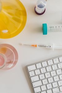 Kaboompics - Syringe and Colorful Laboratory Glassware Flat Lay