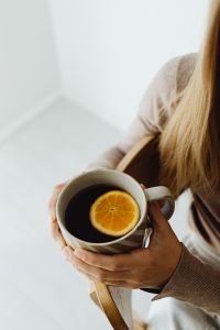 Kaboompics - Woman Sitting With a Cup of Orange Tea