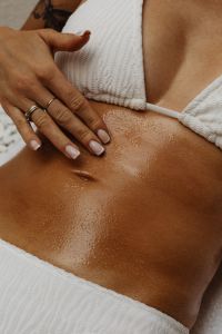 Kaboompics - Close-Up of Sun-Kissed Skin and Hand in a White Bikini