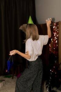 Kaboompics - Woman in Green Party Hat with Nostalgic Birthday Details