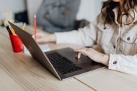 Kaboompics - Woman Using Laptop with Man in Background