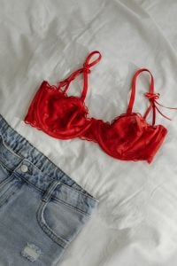 Kaboompics - Red Satin Bra and Blue Jeans on White Bedding