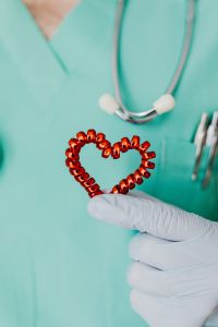 Kaboompics - Heart-Shaped Prop Held Against Medical Scrubs