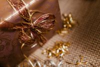 Kaboompics - Macro of Gold Mesh Ribbon Bow on Wrapped Gift, Festive New Year Detail