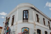 Kaboompics - White Rounded Corner Building with Street Art Mural and Graffiti