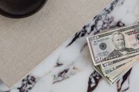 Kaboompics - Vertical Dollar Bills Beside Beige Linen and Marble