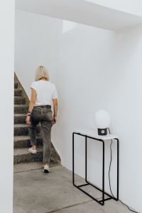 Kaboompics - Blonde Woman Walking Up Stone Stairs in a White T-Shirt, Minimal Lifestyle Photo with Copy Space