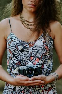 Woman in a dress with a camera