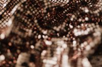 Kaboompics - Soft-Focus Rose Gold Sequin Fabric with Dark Folded Shadows, Glitter Background
