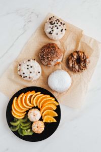 Kaboompics - Donut and Kiwi Breakfast with a Coffee Cup at the Edge of White Marble